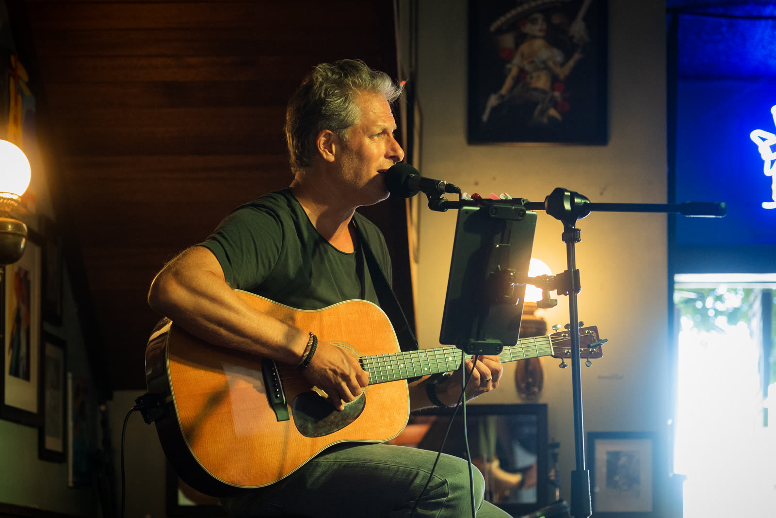 Pascal singing into the microphone at the No Name Bar