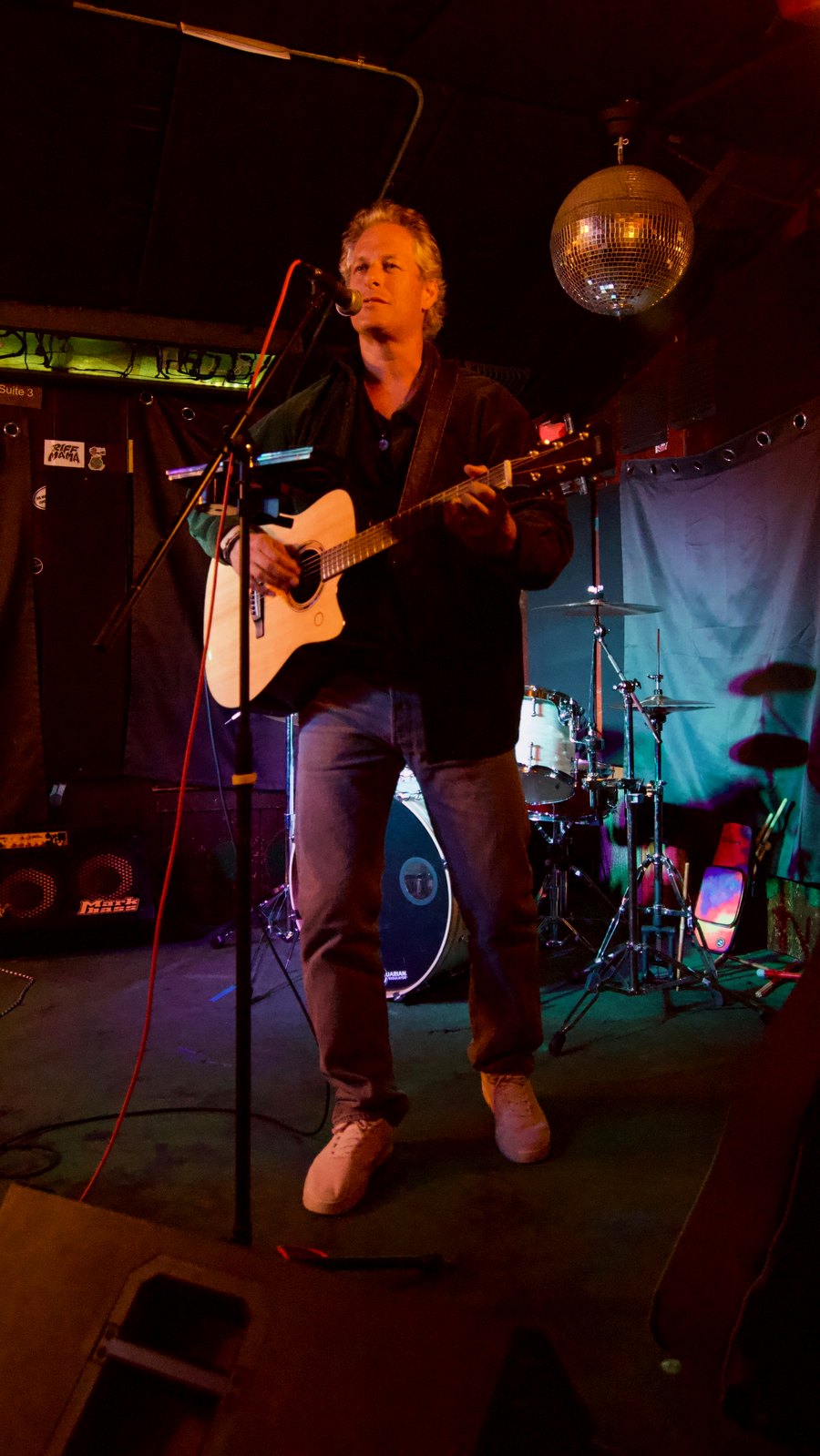 Pascal mid-performance with acoustic guitar